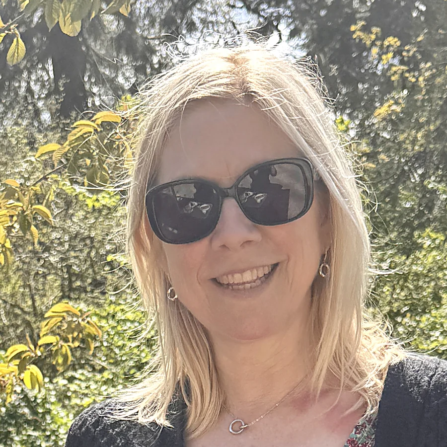Georgia Clare, standing in a garden in spring sunshine